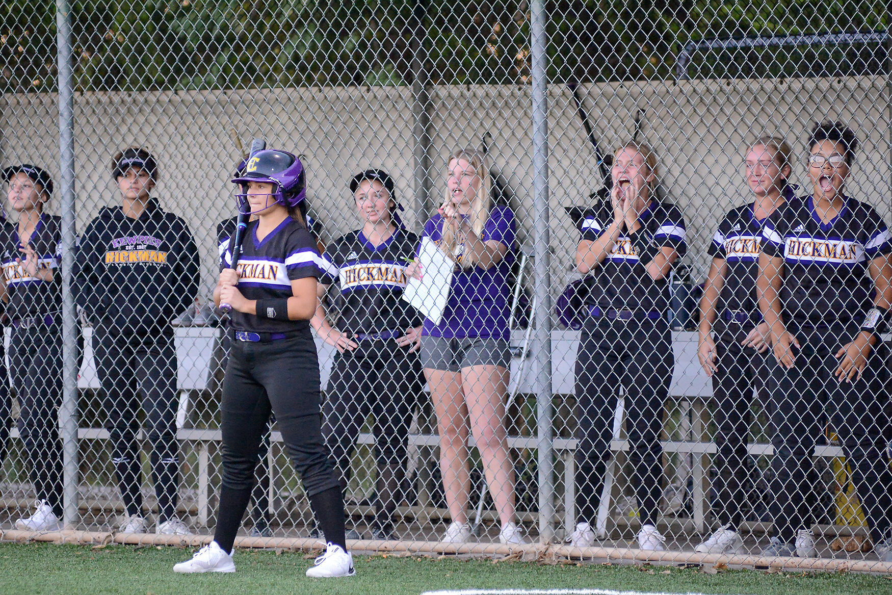 The Hickman softball team chants during the last at-bat in the 7th inning